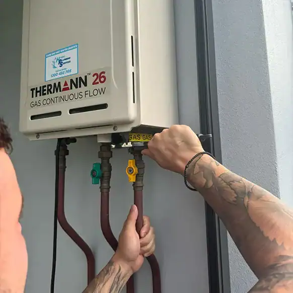 Hydro plumber working on a Thermann hot water system