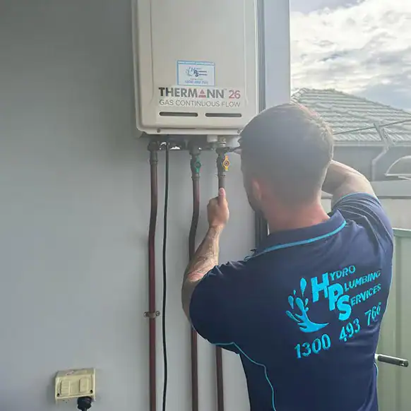 Hydro Plumbing Services plumber installing a hot water system
